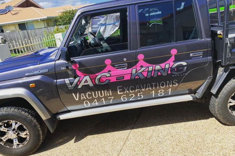 car wraps - pink sign on black vehicle
