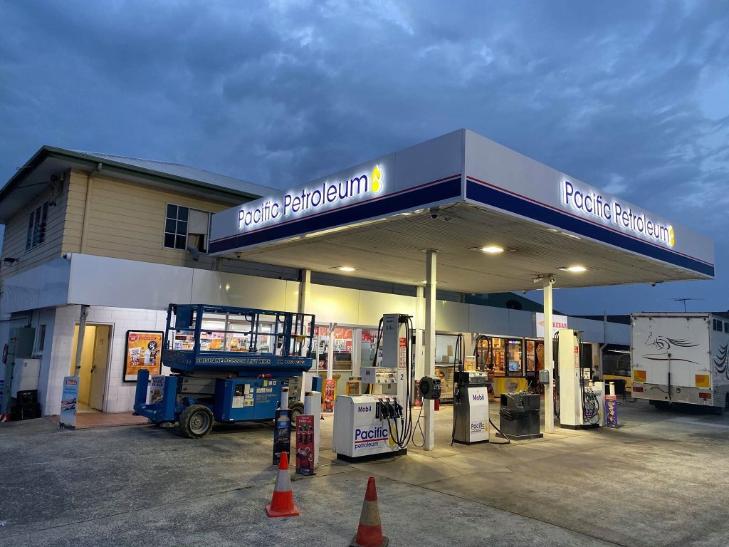Signage for a petrol station at night